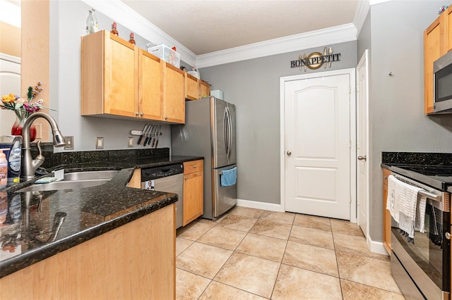 kitchen with appliances with stainless steel finishes, dark stone countertops, sink, and ornamental molding