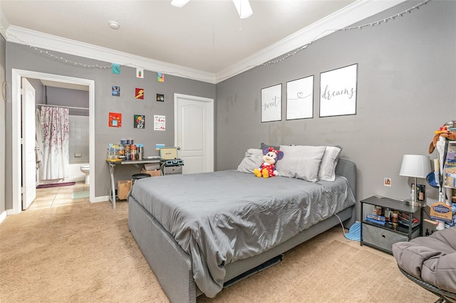 bedroom featuring ornamental molding, light carpet, ceiling fan, and connected bathroom