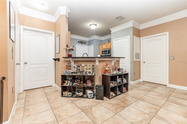 kitchen with ornamental molding and light tile patterned flooring