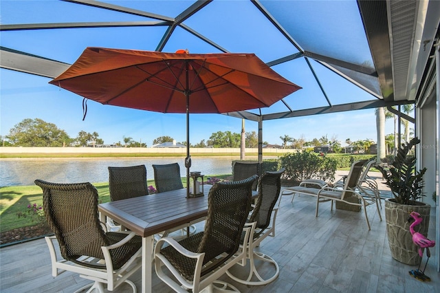 view of patio / terrace with glass enclosure and a water view