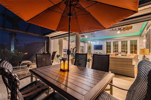 patio at night featuring outdoor lounge area