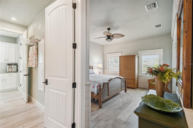 bedroom with light wood-type flooring and ceiling fan