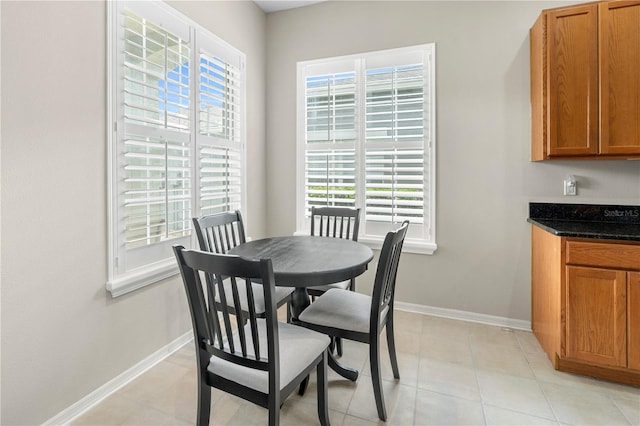 dining room with light tile patterned flooring and plenty of natural light