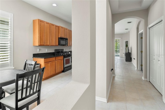 kitchen featuring stainless steel gas range and light tile patterned floors