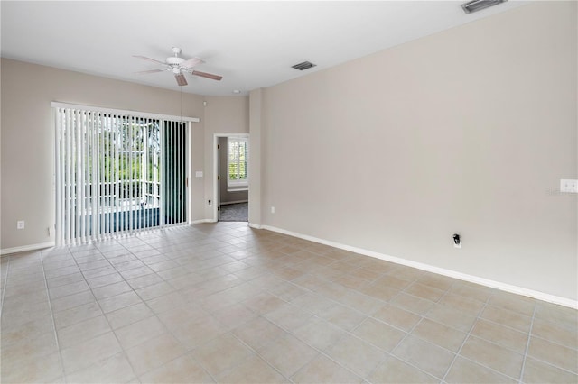 unfurnished room featuring light tile patterned floors and ceiling fan