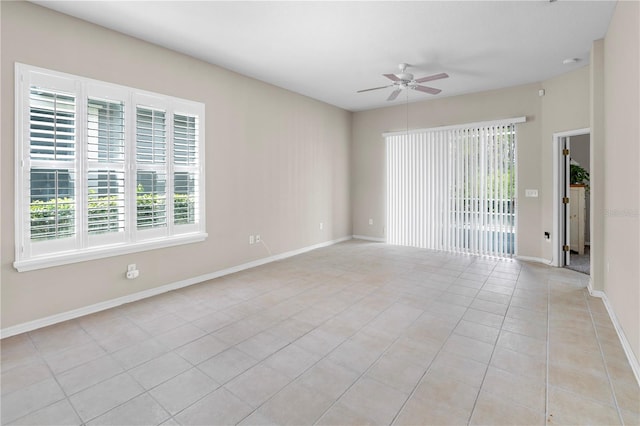 tiled empty room with ceiling fan