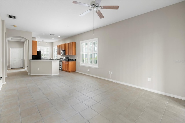 unfurnished living room featuring light tile patterned floors and ceiling fan