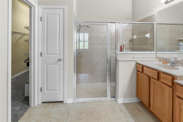 bathroom featuring walk in shower, tile patterned flooring, and vanity