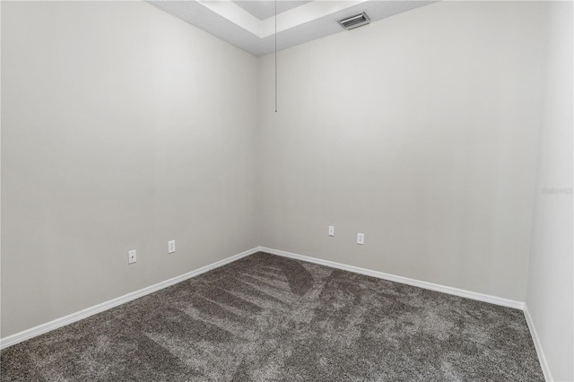 unfurnished room with dark colored carpet