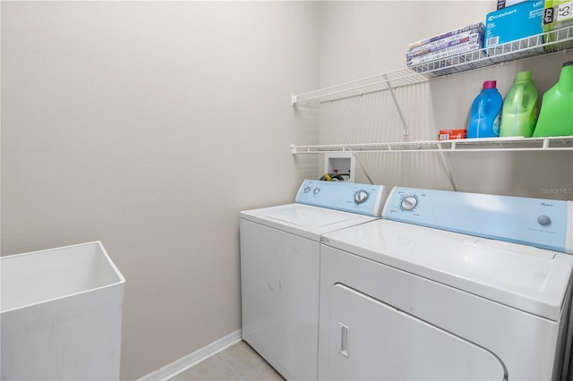 washroom featuring independent washer and dryer and light tile patterned floors