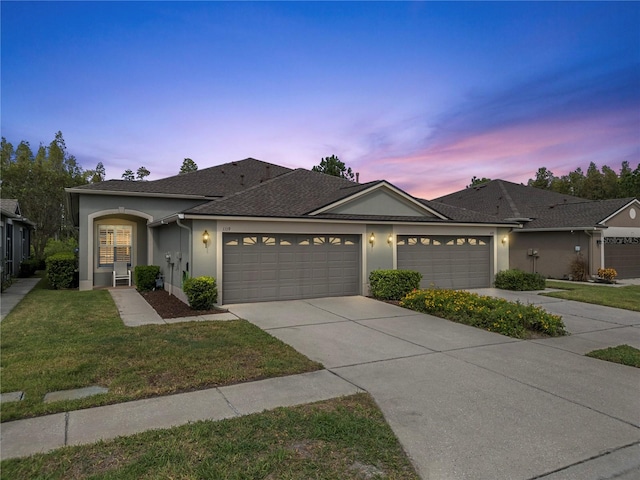 view of front of house featuring a garage and a yard