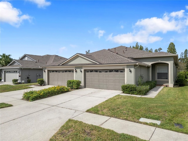 ranch-style home with a front yard and a garage