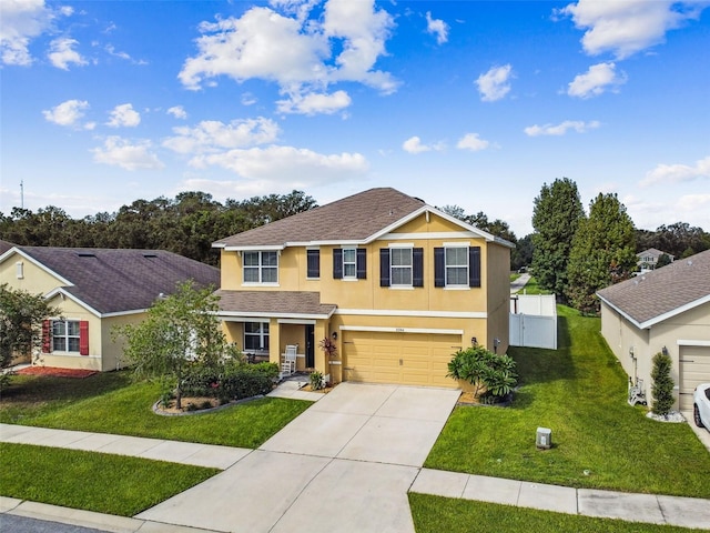 view of front of house with a front lawn, driveway, stucco siding, and a garage