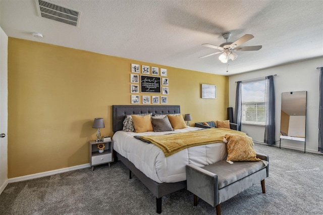 carpeted bedroom featuring baseboards, a textured ceiling, visible vents, and ceiling fan