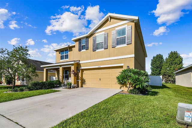 view of front of home with a front lawn, stucco siding, a garage, and concrete driveway