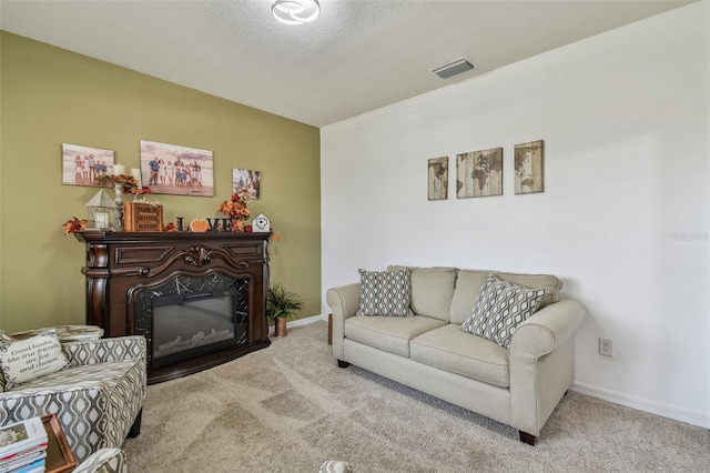 living area featuring baseboards, visible vents, carpet, and a premium fireplace