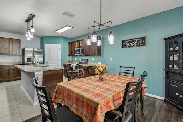 dining room featuring sink and dark wood-type flooring