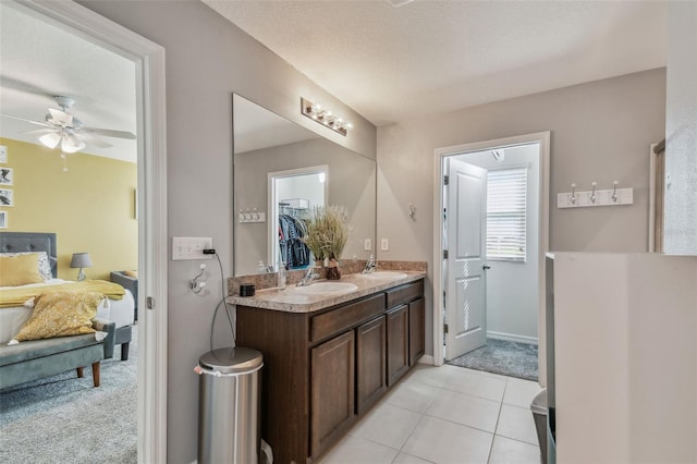 bathroom featuring a textured ceiling, tile patterned flooring, vanity, and ceiling fan