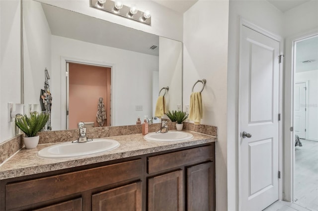 full bathroom with double vanity, a sink, and visible vents