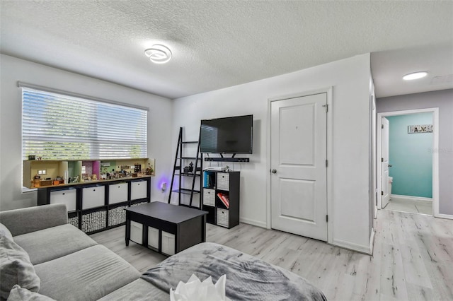 living area with baseboards and light wood-style flooring