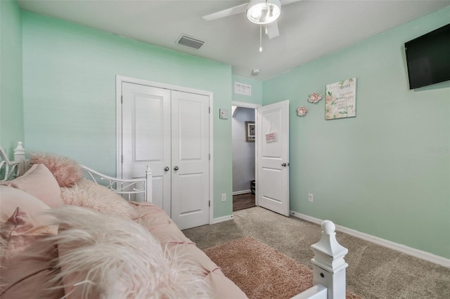 bedroom with a closet, visible vents, carpet, baseboards, and ceiling fan