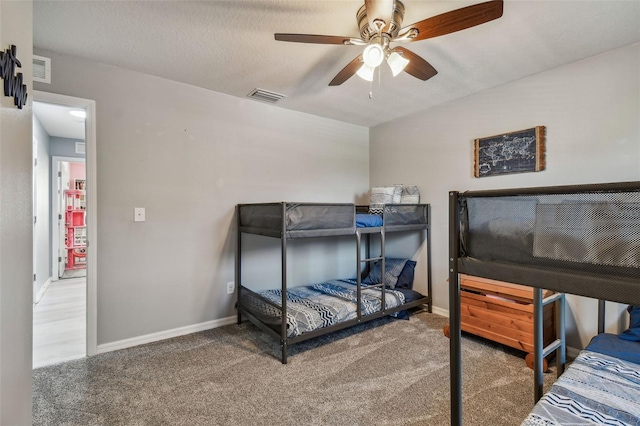 bedroom featuring ceiling fan and a textured ceiling