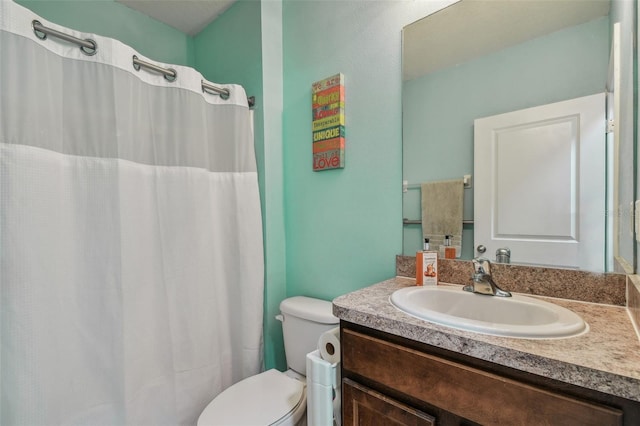 bathroom with a shower with curtain, toilet, and vanity