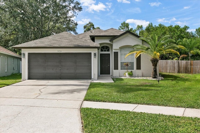 single story home featuring a garage and a front yard