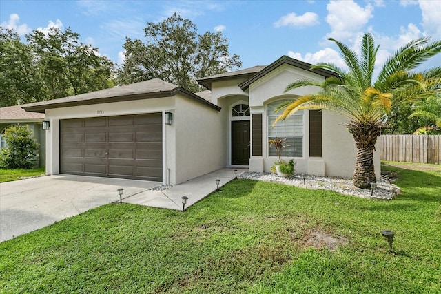 ranch-style house featuring a front lawn and a garage