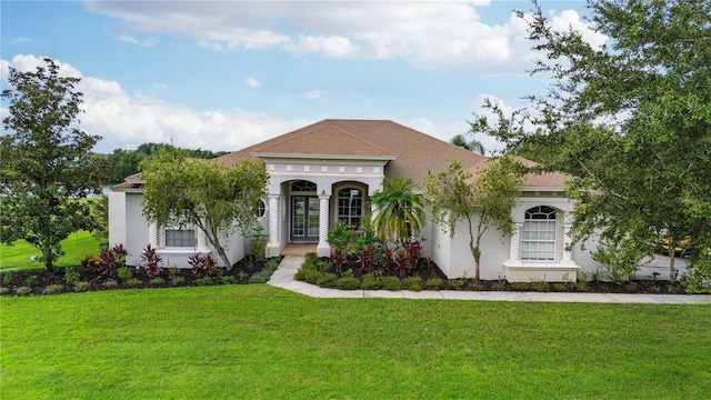 mediterranean / spanish-style house featuring a front yard