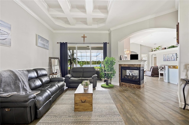 living room featuring a multi sided fireplace, coffered ceiling, crown molding, beam ceiling, and hardwood / wood-style flooring