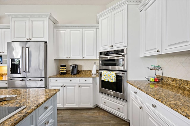 kitchen featuring stainless steel appliances, white cabinets, and dark wood-type flooring