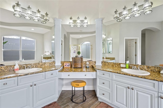 bathroom with vanity, hardwood / wood-style flooring, and a shower with shower door