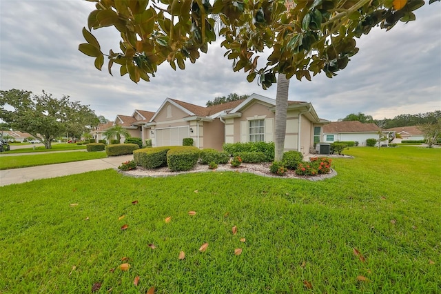 view of front of property with a garage and a front lawn