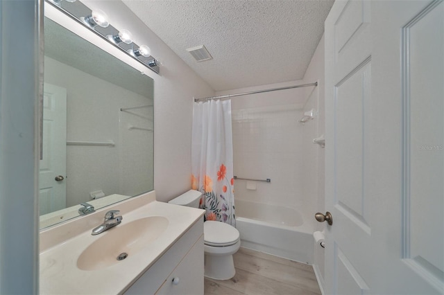 full bathroom with vanity, a textured ceiling, shower / tub combo with curtain, hardwood / wood-style floors, and toilet