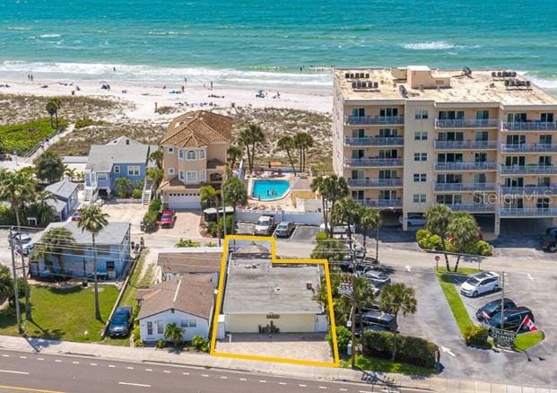 birds eye view of property featuring a water view and a view of the beach