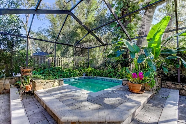 view of swimming pool featuring a patio and glass enclosure