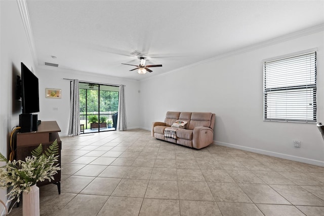 sitting room with ceiling fan, crown molding, and light tile patterned floors