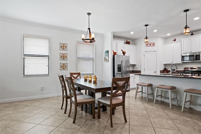 dining area featuring light tile patterned flooring, crown molding, sink, and a notable chandelier