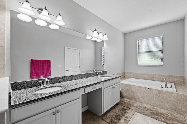 bathroom featuring vanity, tile patterned flooring, and tiled tub