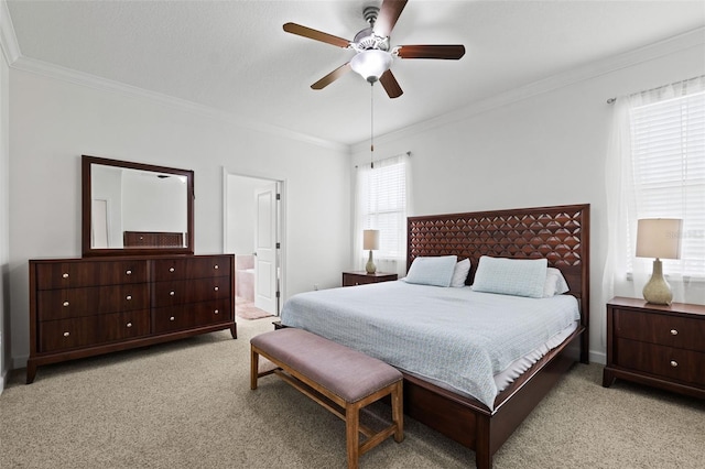 bedroom with ensuite bath, light carpet, ornamental molding, and ceiling fan