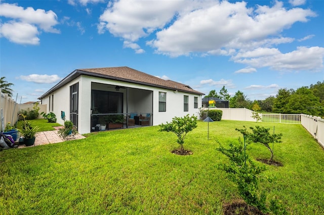 back of house with a yard, a sunroom, and a patio