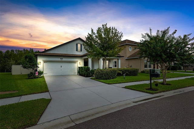 view of front facade with a lawn and a garage