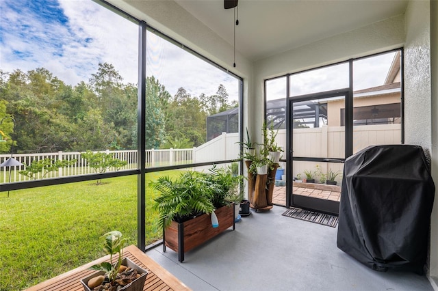 sunroom / solarium featuring ceiling fan