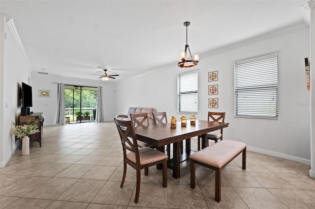 tiled dining space with ornamental molding and ceiling fan with notable chandelier