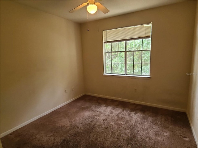 carpeted empty room featuring ceiling fan