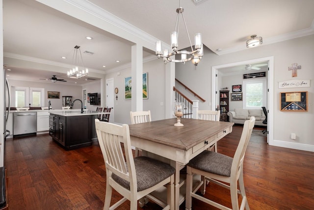 dining room with ornamental molding, dark wood-type flooring, and ceiling fan with notable chandelier