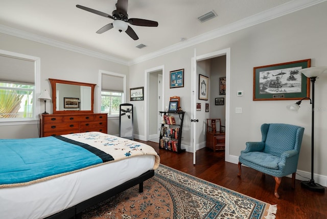 bedroom with dark wood-type flooring, ceiling fan, and ornamental molding