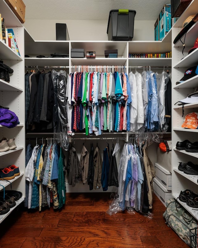 spacious closet with dark hardwood / wood-style flooring