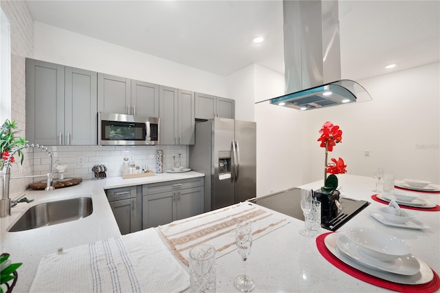 kitchen with gray cabinets, stainless steel appliances, backsplash, and island range hood